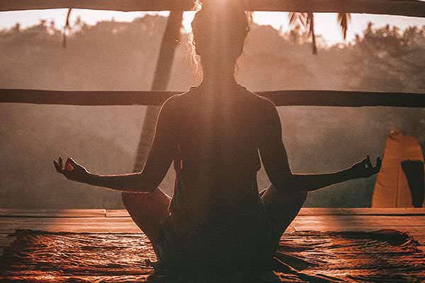 Person seated in a relaxed meditation pose