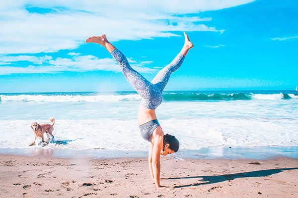 Small group yoga class flowing through a pose together